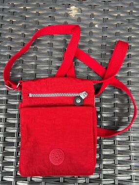 Like new-Nylon Red Kipling Crossbody Travel Pouch with Front Zip. Canvas straps.